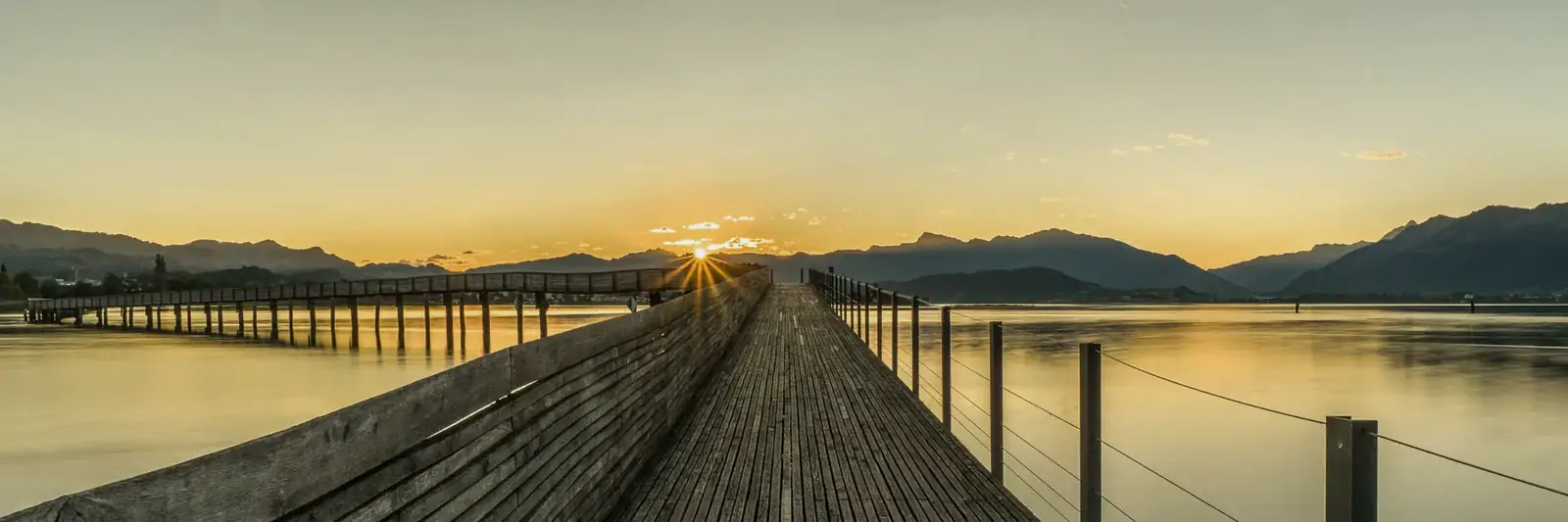 The wooden Seedamm footbridge at sunrise, Pfäffikon SZ